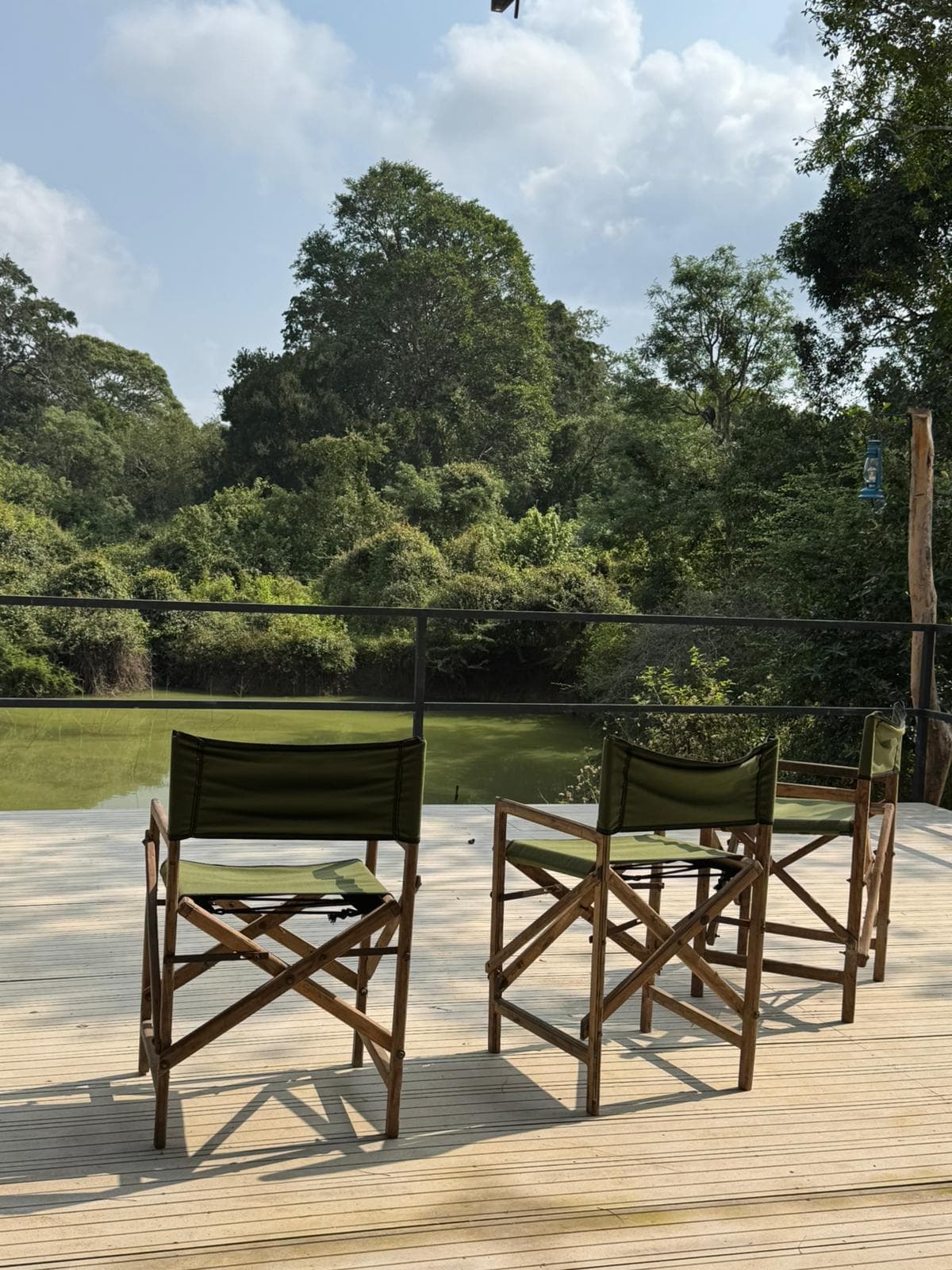 Two directors chairs set out on the deck facing the waterhole