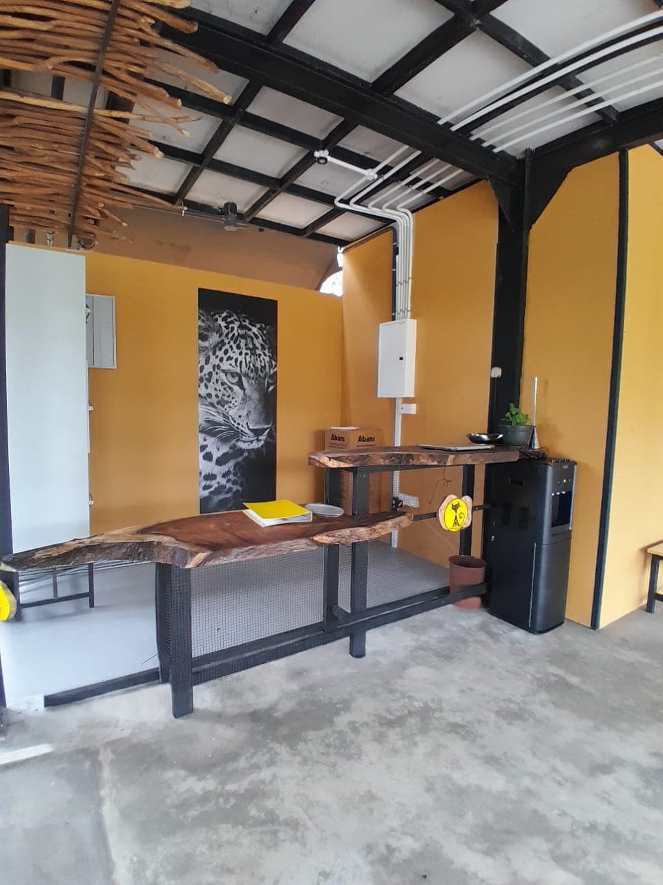 The reception area with its long timber table and concrete floor